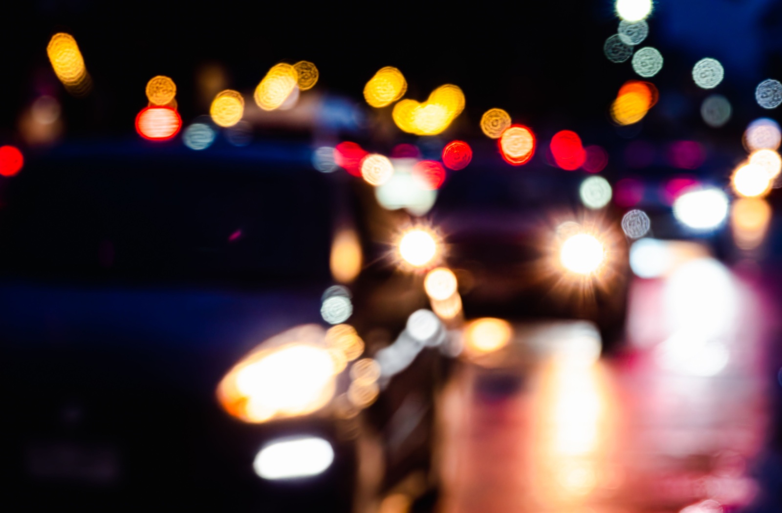 Halos, blurry, and distorted light from oncoming car traffic, demonstrates how astigmatism affects night driving.