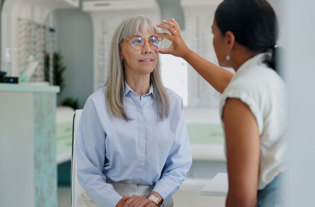 An optometrist places AR glasses on their patient and explains how they can improve nighttime driving conditions.