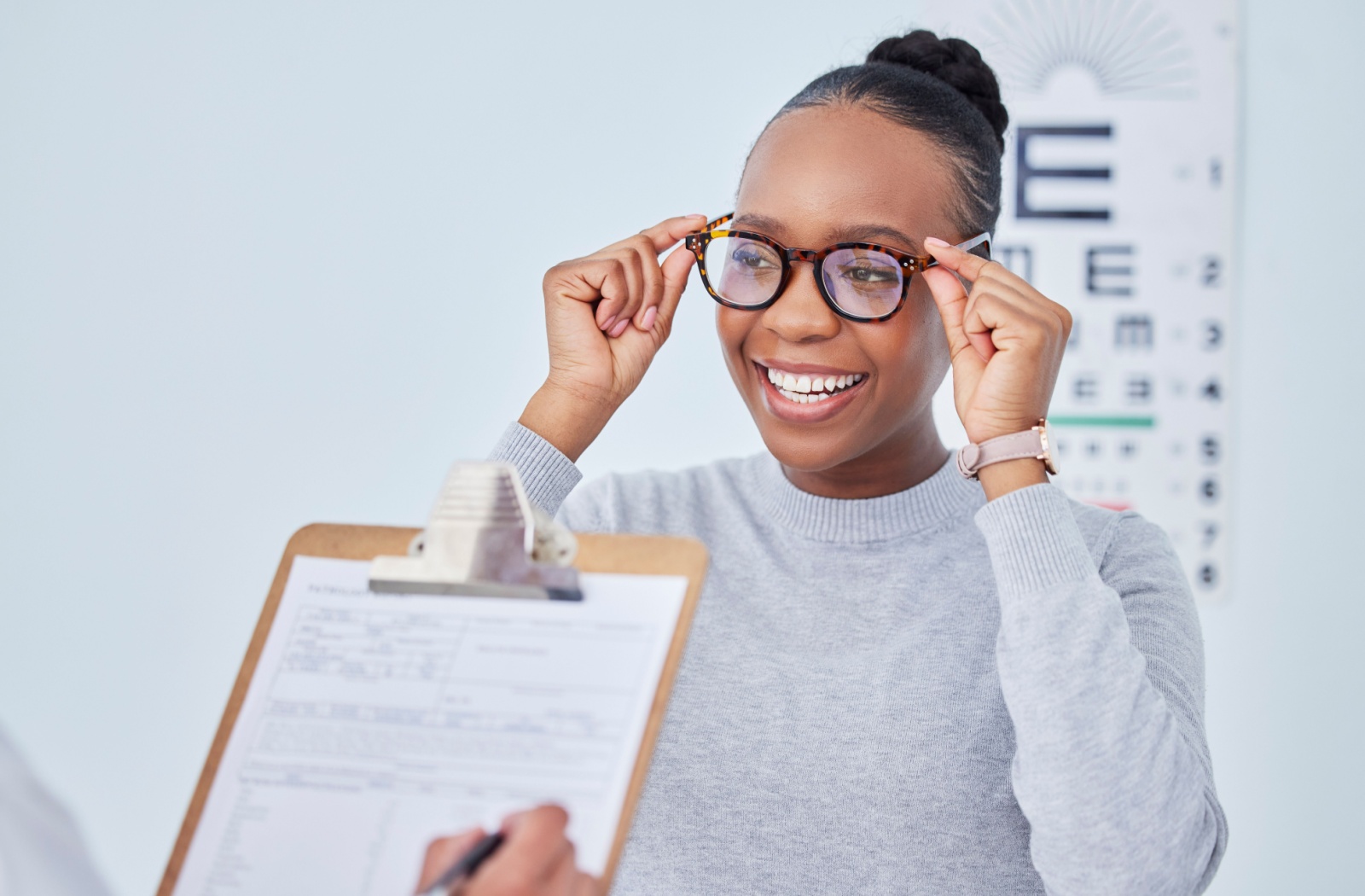 Smiling patient getting new frames at an optometry clinic
